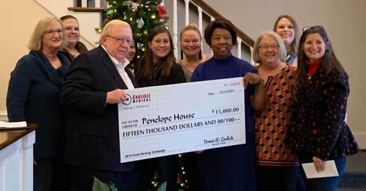 2019 Penelope House Board Members receiving the check from Mr. Carlisle